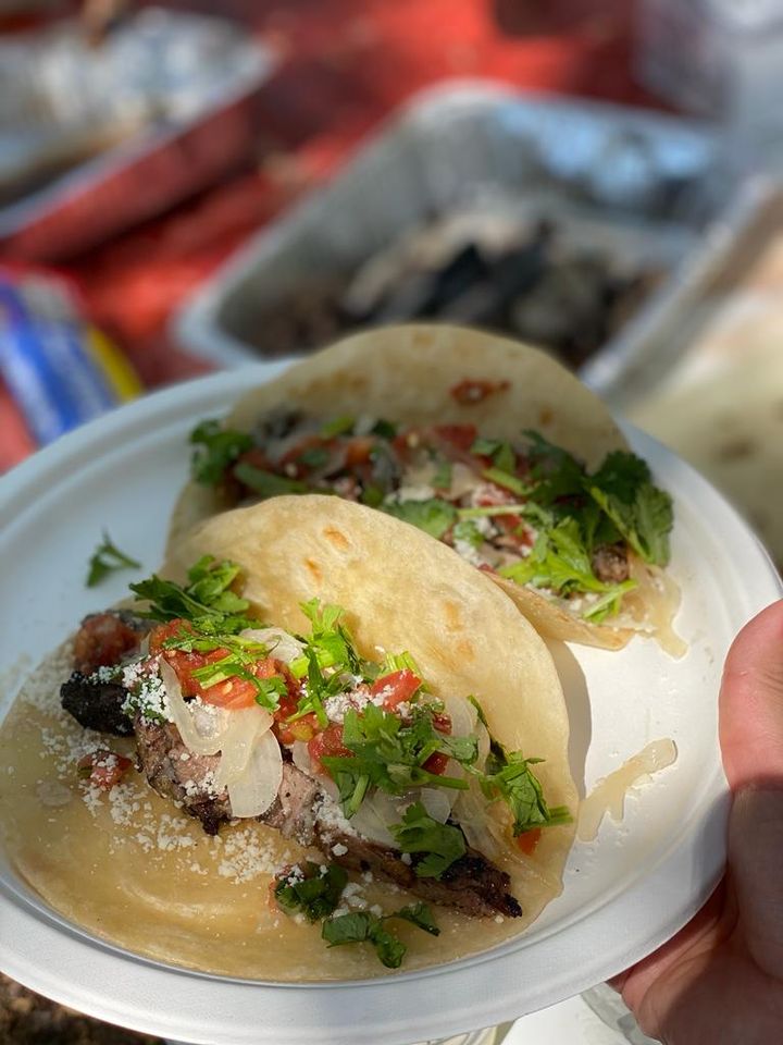 Carnitas tacos with fresh corn tortillas.